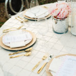 A table set with plates, silverware and napkins.