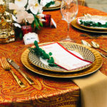 A table set with plates, silverware and place cards.