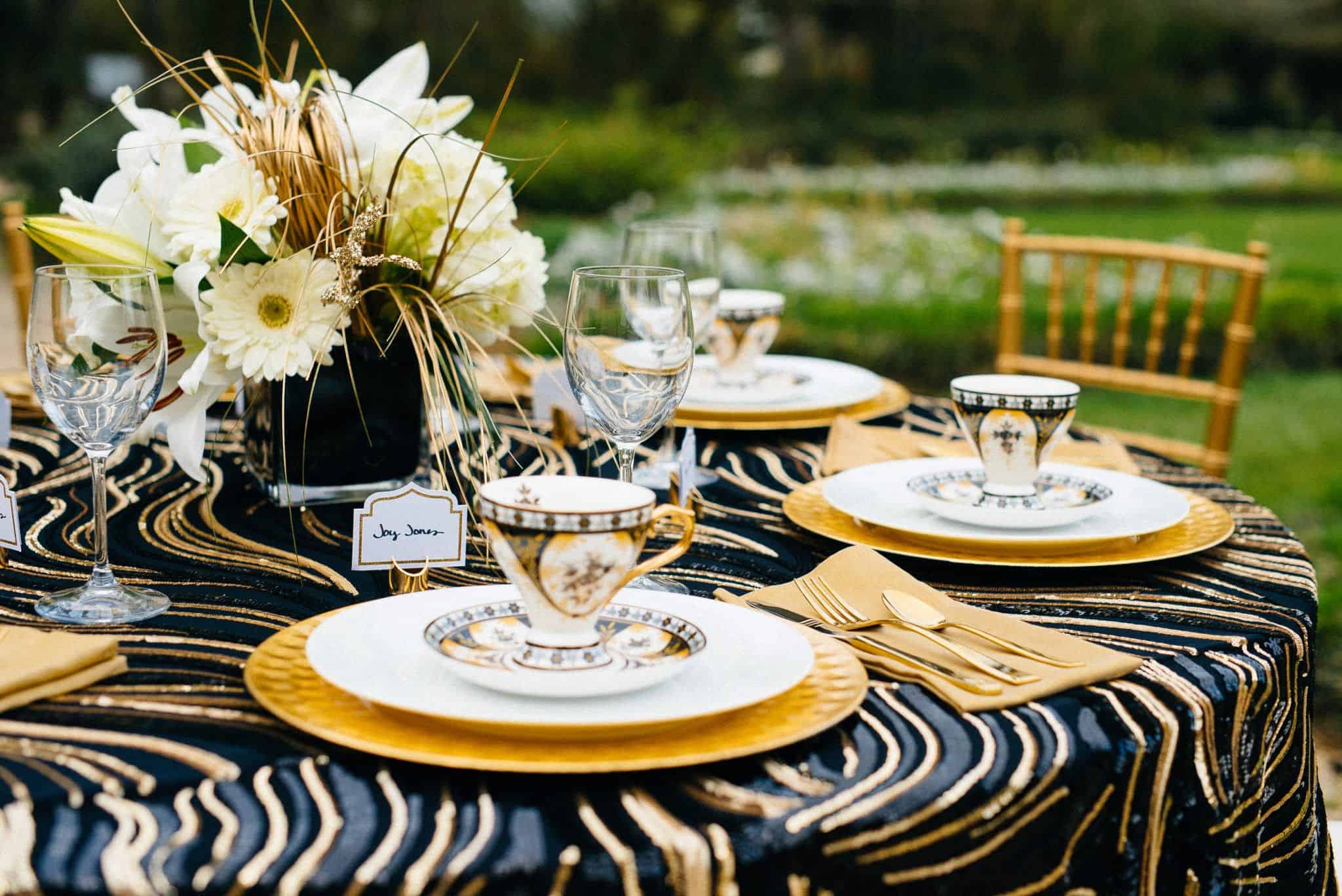 A table set with plates and cups on top of zebra print.